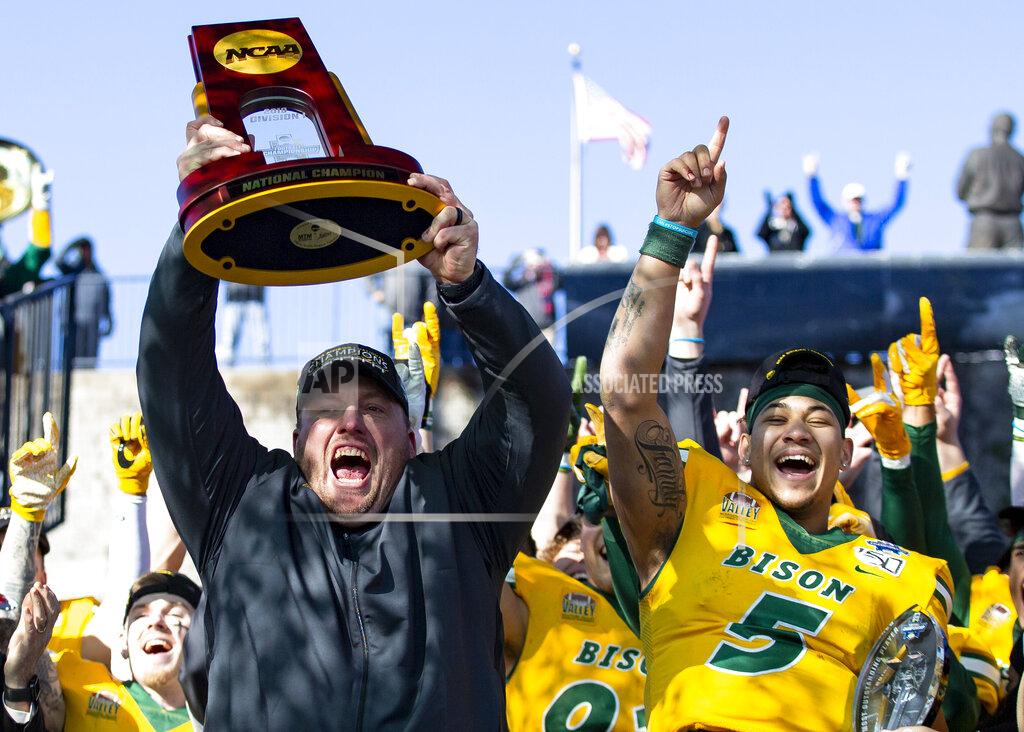 FILE - In this Jan. 11, 2020, file photo, North Dakota State head coach Matt Entz raises the trophy alongside quarterback Trey Lance (5) as they celebrate after beating James Madison 28-20 in the FCS championship NCAA college football game in Frisco, Texas. Entz says the benefits of practicing for a one-game season this year, outweighed the risks and frustration from dealing with the coronavirus. The Bison have been practicing for the last month ahead of Saturday's game against Central Arkansas. (AP Photo/Sam Hodde, File)