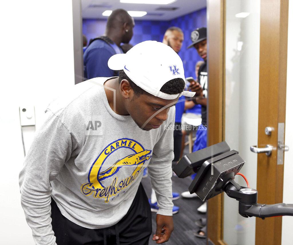 FILE - In this Aug. 4, 2016, file photo, University of Kentucky football manager Jordan Newton has his eyes scanned for the eye retina security system at the new University of Kentucky football training center in Lexington, Ky. Screening technology that scans a user’s eyes, face or fingerprint has multiplied around the world in recent years. (Charles Bertram/Lexington Herald-Leader via AP, File)