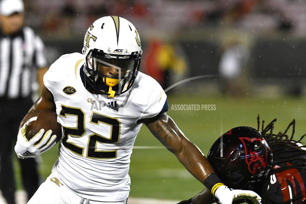 Timothy D. Easley Georgia Tech running back Clinton Lynch (22) blocks Louisville safety Khane Pass (30) as he advances the ball during the first half of an NCAA college football game, Friday, Oct. 5, 2018, in Louisville, Ky. (AP Photo/Timothy D. Easley)