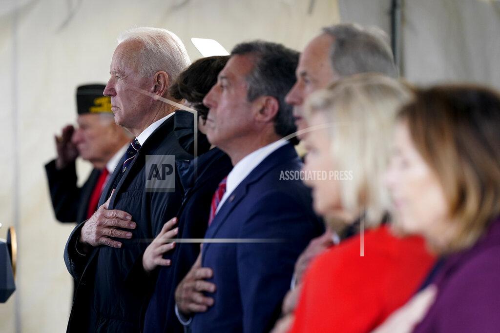Patrick Semansky President Joe Biden stands as a rendition of the national anthem is performed during a Memorial Day event at Veterans Memorial Park at the Delaware Memorial Bridge in New Castle, Del., Sunday, May 30, 2021. (AP Photo/Patrick Semansky)