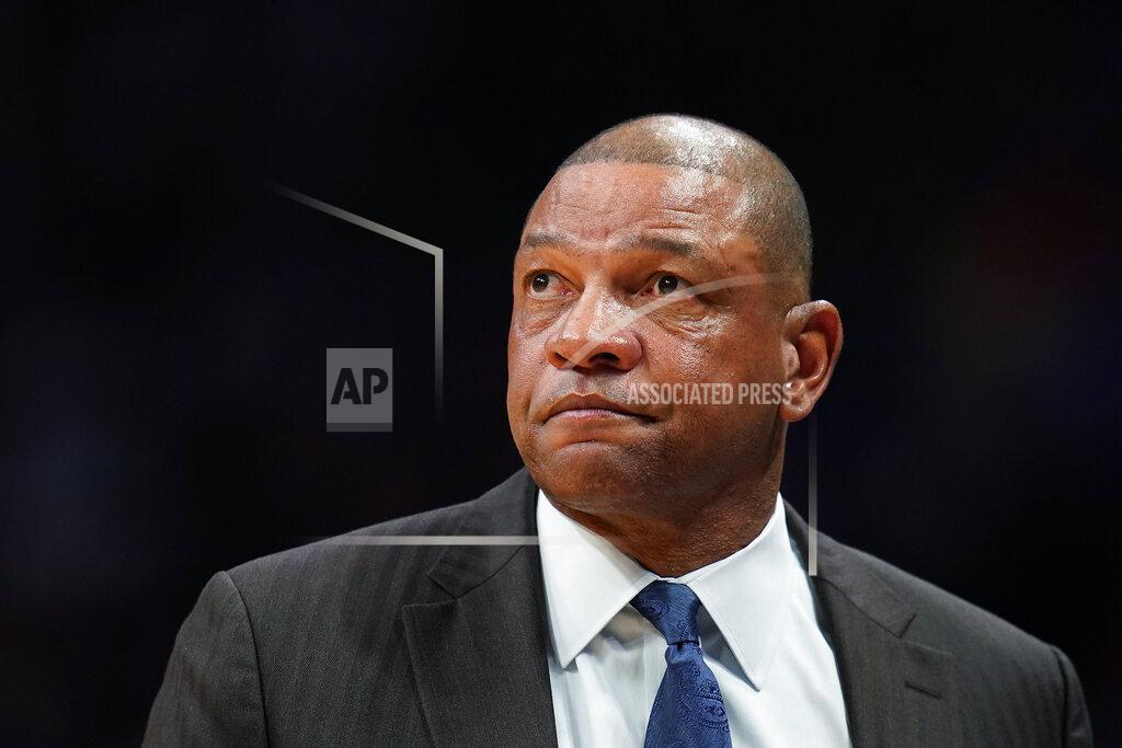 FILE - In this Jan. 12, 2020, file photo, Los Angeles Clippers coach Doc Rivers looks on during the second quarter of the team's NBA basketball game against the Denver Nuggets in Denver. The Philadelphia 76ers introduced Rivers as their head coach on Monday, Oct. 5, 2020. Rivers takes over as the 25th head coach in 76ers history after a seven-season run as head coach of the Clippers. (AP Photo/Jack Dempsey, File)