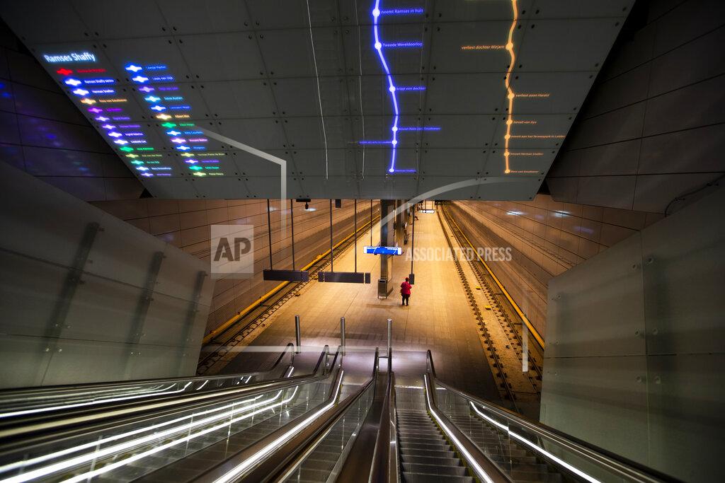 Peter Dejong A lone traveller waits for the metro on a near-deserted platform in Amsterdam, Netherlands, Friday, April 24, 2020. The Dutch largely heed government guidelines to stay at home to curb the spread of the coronavirus. (AP Photo/Peter Dejong)