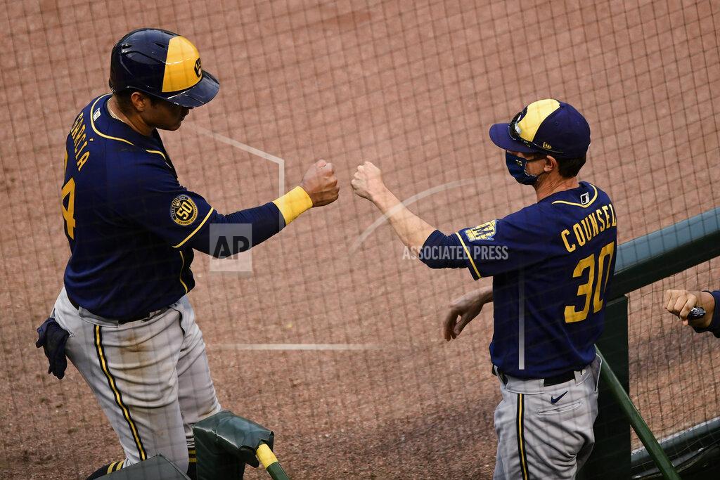 Paul Beaty Milwaukee Brewers' Avisail Garcia (24) celebrates with manager Craig Counsell (30) at the dugout after scoring on a Luis Urias single during the 10th inning of a baseball game against the Chicago Cubs on Saturday, Aug. 15, 2020, in Chicago. Milwaukee won 6-5 in 10 innings. (AP Photo/Paul Beaty)