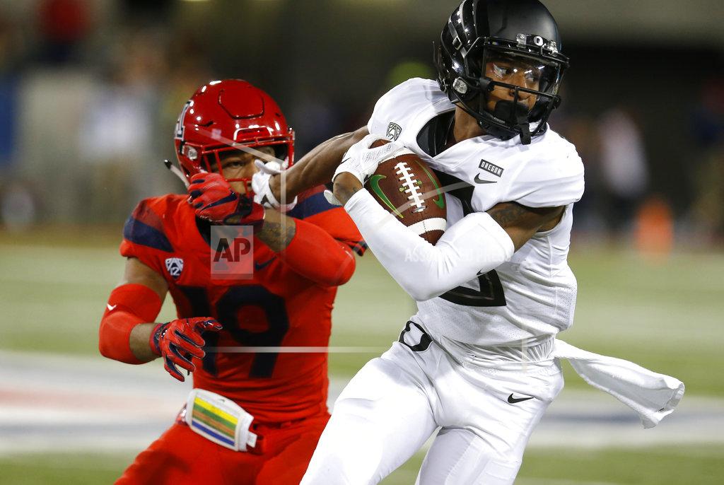 Rick Scuteri Oregon wide receiver Dillon Mitchell stiff arms Arizona safety Scottie Young Jr. (19) in the first half during an NCAA college football game, Saturday, Oct. 27, 2018, in Tucson, Ariz. (AP Photo/Rick Scuteri)