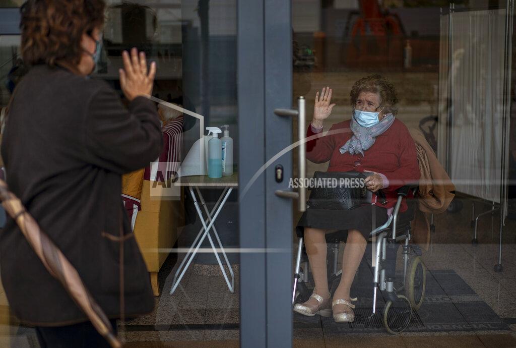 Emilio Morenatti Through a window, Angels Trepat, 59, says goodbye to her mother Angelina, 91, after visiting her at the Icaria nursing home in Barcelona, Spain, Friday, Nov. 27, 2020. Virus cases among the elderly are again on the rise across Europe, causing havoc and rising death tolls in nursing homes despite the lessons of a tragic spring. Authorities are in a race to save lives as they wait for crucial announcements on mass vaccinations. (AP Photo/Emilio Morenatti)