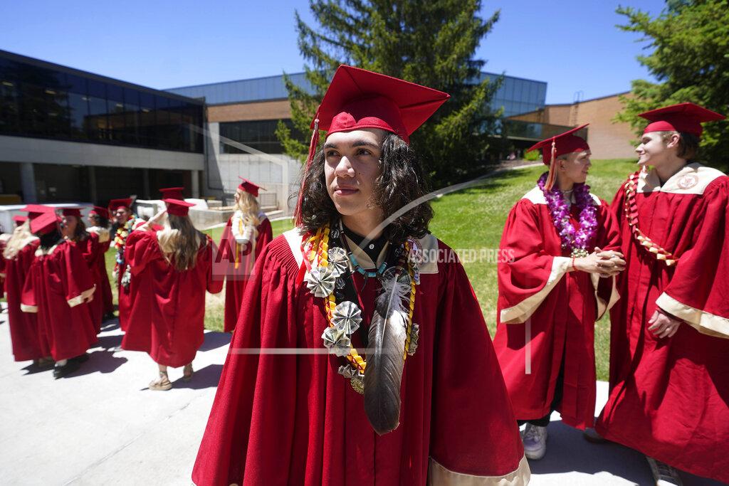 Rick Bowmer Elijah Wiggins wears an eagle feather at his graduation from Cedar City High School Wednesday from Cedar City High School on Wednesday, May 25, 2022, in Cedar City, Utah. Wiggins crossed the stage to accept his diploma wearing an eagle feather that his uncle, Hoksila Lakota, had gifted him ahead of the ceremony to celebrate his graduation. (AP Photo/Rick Bowmer)
