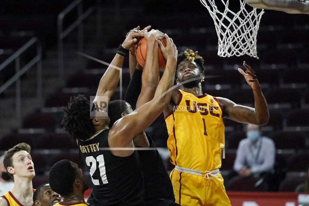 Jae C. Hong Southern California's Chevez Goodwin, right, fights for a rebound with Colorado's Evan Battey, left, and Jeriah Horne during the second half of an NCAA college basketball game Thursday, Dec. 31, 2020, in Los Angeles. Colorado won 72-62. (AP Photo/Jae C. Hong)
