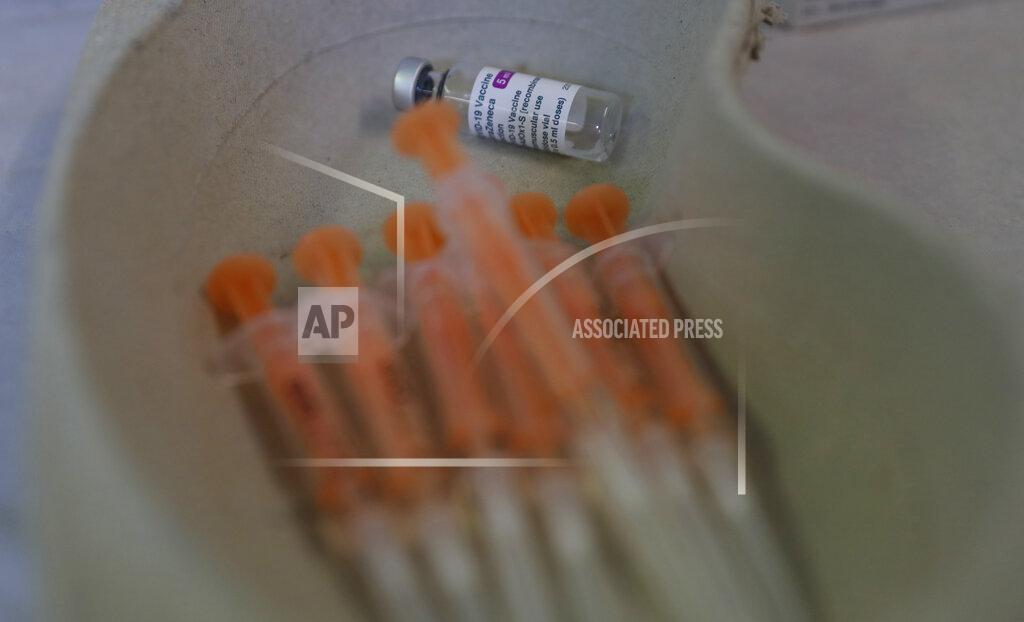 Alastair Grant A vial and syringes ready for use of the AstraZeneca COVID-19 vaccine at the Wheatfield surgery in Luton, England, Thursday, March 18, 2021. The world is awaiting the results of an initial European investigation into whether there is any evidence that the AstraZeneca coronavirus vaccine was behind unusual blood clots reported in some recipients of the shot. (AP Photo/Alastair Grant)