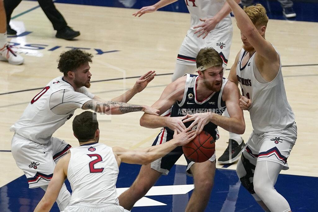 Jeff Chiu Gonzaga forward Drew Timme, middle, drives between Saint Mary's guard Logan Johnson (0), guard Quinn Clinton (2) and forward Matthias Tass during the second half of an NCAA college basketball game in Moraga, Calif., Saturday, Jan. 16, 2021. (AP Photo/Jeff Chiu)