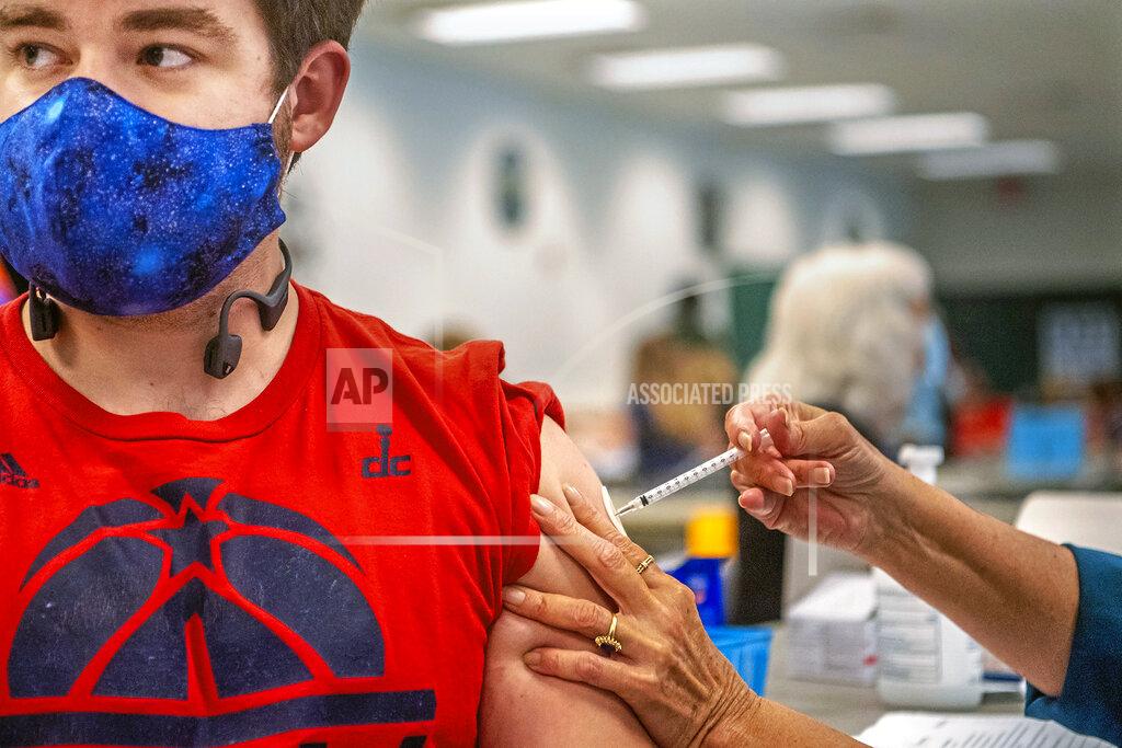 Alexandra Wimley Eric Pierce, 24, of Pittsburgh, receives a COVID-19 vaccine at a clinic run by Spartan Pharmacy at the Broughton Volunteer Fire Department, Wednesday, April 7, 2021, in South Park, Pa. (Alexandra Wimley/Pittsburgh Post-Gazette via AP)