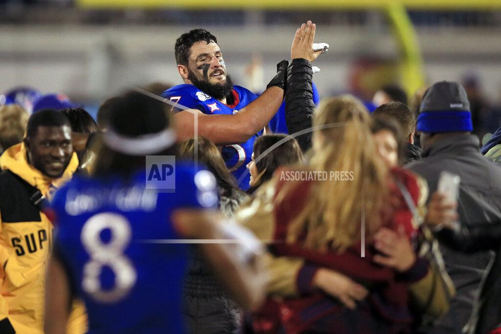 Orlin Wagner Kansas offensive lineman Kevin Feder (67) high-fives fans following an NCAA college football game against Texas Tech in Lawrence, Kan., Saturday, Oct. 26, 2019. Kansas defeated Texas Tech 37-34. (AP Photo/Orlin Wagner)