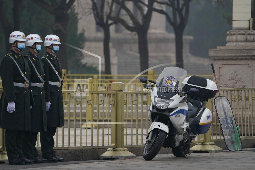 Ng Han Guan Chinese security personnel stand guard near the Great Hall of the People in Beijing Wednesday, March 3, 2021. In a sign of confidence China has reverted back to holding its annual Congress meetings to march this year after delaying them due to the outbreak of the coronavirus last year. As usual, security has been tightened in the capital with paramilitary troops patrolling near the Great Hall of the People where the meetings are held and standing guard at subway stations. (AP Photo/Ng Han Guan)