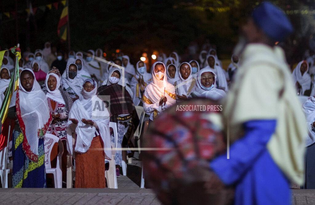 Mulugeta Ayene Ethiopian Orthodox Christians light candles and pray for peace during a church service at the Medhane Alem Cathedral in the Bole Medhanealem area of the capital Addis Ababa, Ethiopia Thursday, Nov. 5, 2020. Ethiopia's powerful Tigray region asserts that fighter jets have bombed locations around its capital, Mekele, aiming to force the region "into submission," while Ethiopia's army says it has been forced into an "unexpected and aimless war." (AP Photo/Mulugeta Ayene)