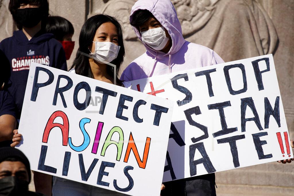 Nam Y. Huh FILE - This March 20, 2021, file photo shows people holding signs as they attend a rally to support Stop Asian Hate at the Logan Square Monument in Chicago. A national coalition of civil rights groups will release on Wednesday, July 28, 2021, a comprehensive, state-by-state review of hate crime laws in the United States. Members of the coalition say the report sets the stage for bolstering the efficacy of current law and addresses racial disparities in how the laws are enforced. (AP Photo/Nam Y. Huh, File)