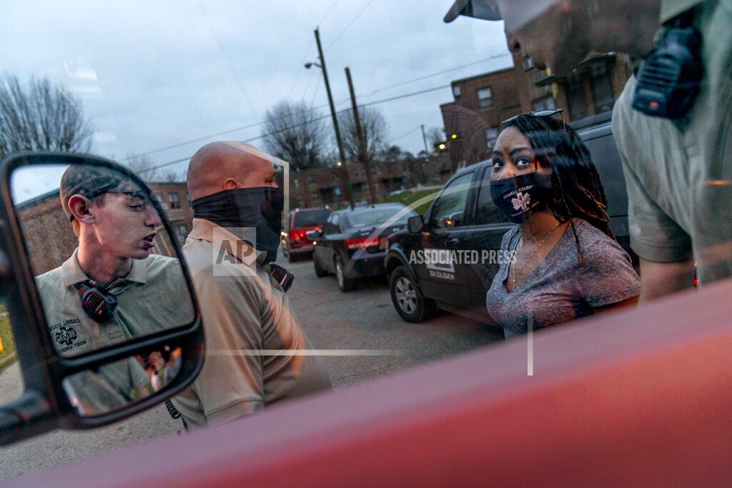 David Goldman Larrecsa Cox, right, who leads the Quick Response Team whose mission is to save every citizen who survives an overdose from the next one, talks with paramedics at an overdose call in Huntington, W.Va., Wednesday, March 17, 2021. The formation of the team helped bring down the county's overdose rate. Then the pandemic arrived, and Cox watched it undo much of their effort: overdoses shot up again, so did HIV diagnoses. "I can't believe we've lost all these people. But sometimes, you just have to focus on the living," she said. (AP Photo/David Goldman)