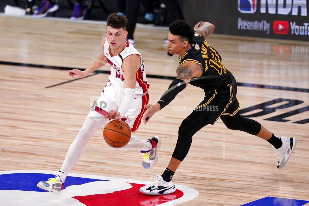 Mark J. Terrill Miami Heat's Tyler Herro, left, and Los Angeles Lakers' Danny Green, right, compete for control of a loose ball during the second half of Game 2 of basketball's NBA Finals, Friday, Oct. 2, 2020, in Lake Buena Vista, Fla. (AP Photo/Mark J. Terrill)