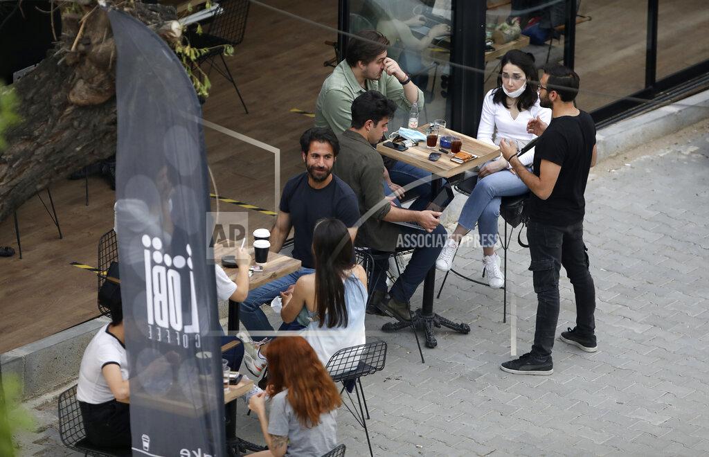 Burhan Ozbilici In this photo taken Saturday, June 6, 2020, people sit outside a cafe, in Ankara, Turkey. Images on social media and news agencies showed crowds picnicking and partying Saturday night without heeding to the rules of social distancing and wearing masks on the first weekend with no lockdown, prompting a reprimand from the health minister who warned that the novel coronavirus continued to pose a threat. (AP Photo/Burhan Ozbilici)