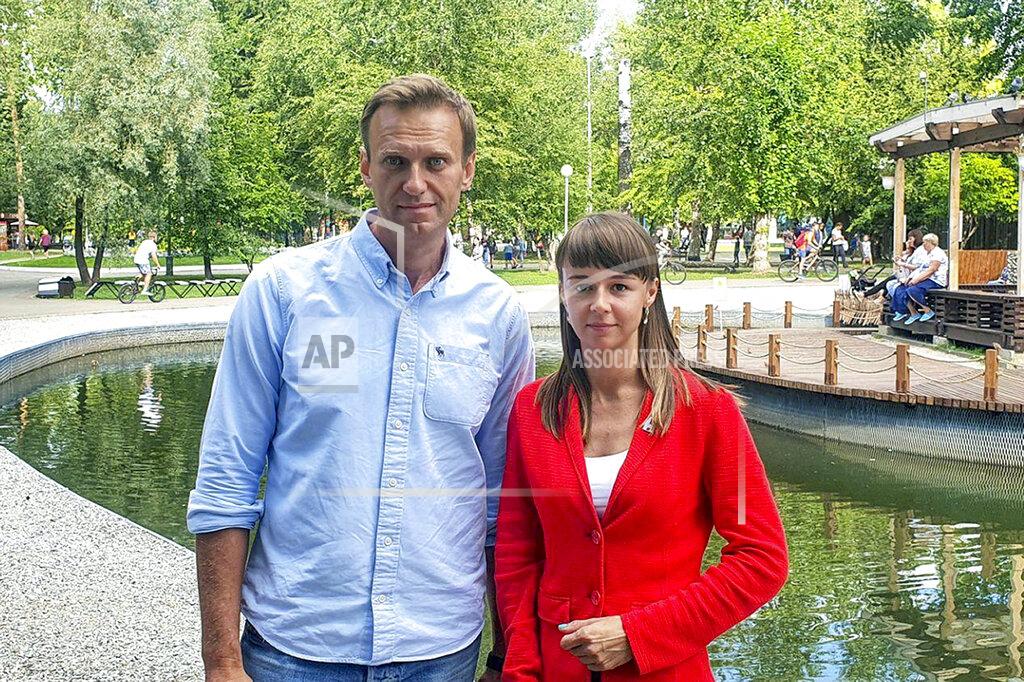In this August 2020, photo, provided by Alexei Navalny's team, Ksenia Fadeyeva, right, poses for a photo with Alexei Navalny in Tomsk, Russia. Fadeyeva runs the regional headquarters in the Siberian city and is running for the Tomsk city council. Fadeyeva has secured a seat in the city council, according to preliminary results of the regional election that took place on Sunday, Sept. 13, 2020. (Andrei Fateyev/Alexei Navalny's team via AP)