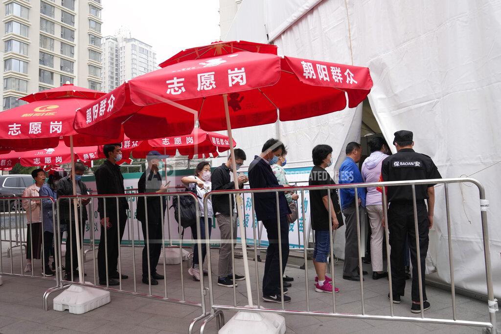 Ng Han Guan Residents line up outside a vaccination center in Beijing on Wednesday, June 2, 2021. After a slow start, China is now doing what virtually no other country in the world can: harnessing the power and all-encompassing reach of its one-party system and a maturing domestic vaccine industry to administer shots at a staggering pace. (AP Photo/Ng Han Guan)