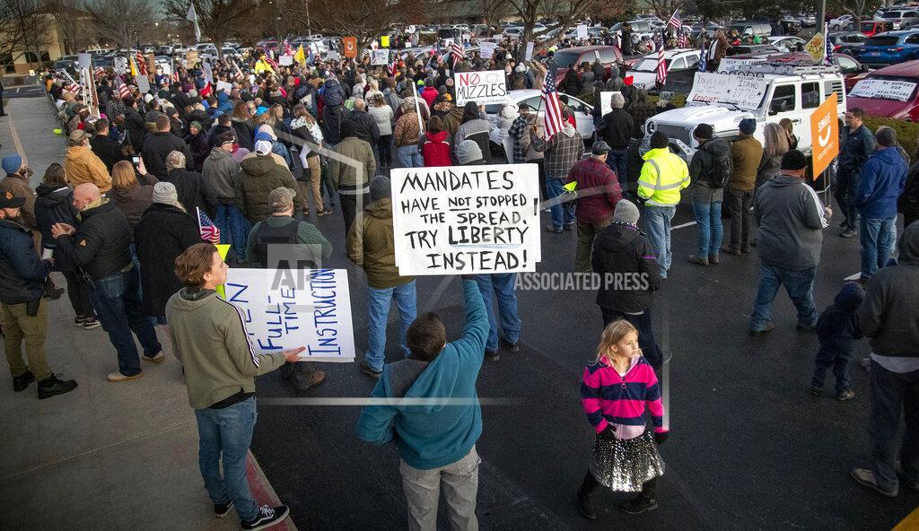 Darin Oswald Anti-masker demonstrators converge on Central District Health offices, Tuesday, Dec. 8, 2020 in Boise, Idaho, to the protest a meeting deciding on more mandates to combat the spread of COVID-19. (Darin Oswald/Idaho Statesman via AP)