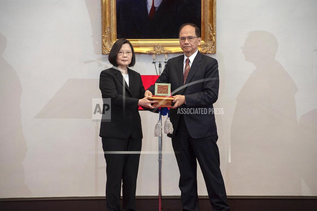 Uncredited In this photo released by the Taiwan Presidential Office, Taiwanese President Tsai Ing-wen, left, holds up a seal with Parliament top speaker You Shi-kun during an inauguration ceremony at the Presidential office in Taipei, Taiwan on Wednesday, May 20, 2020. Tsai has been inaugurated for a second term amid increasing pressure from China on the self-governing island democracy it claims as its own territory. (Taiwan Presidential Office via AP)