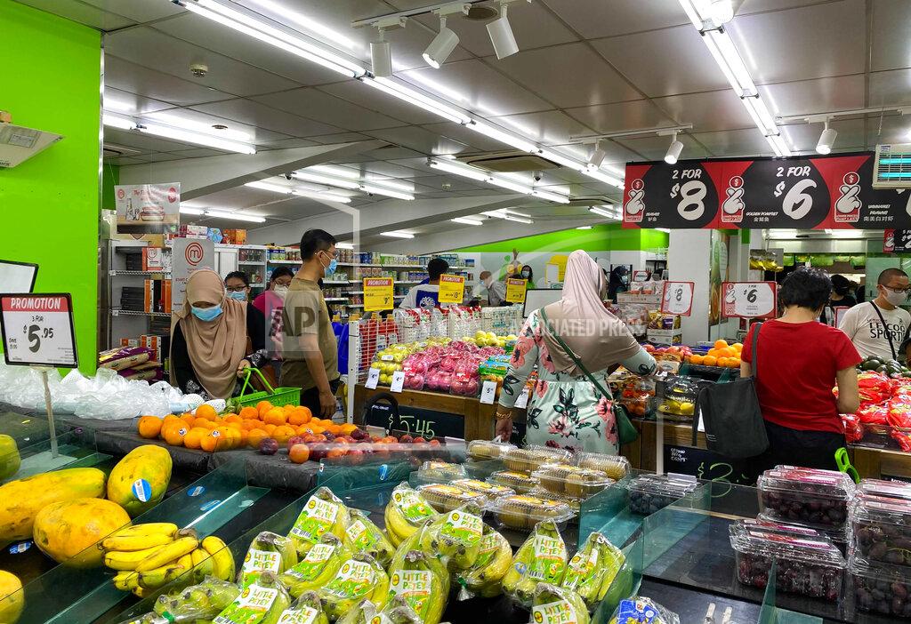 Zen Soo People wear face masks while shopping for groceries at a supermarket in Singapore, Friday, May 14, 2021. Singapore further tightened its COVID-19 measures as it sought to control an increase in untraceable coronavirus infections in the city-state. (AP Photo/Zen Soo)