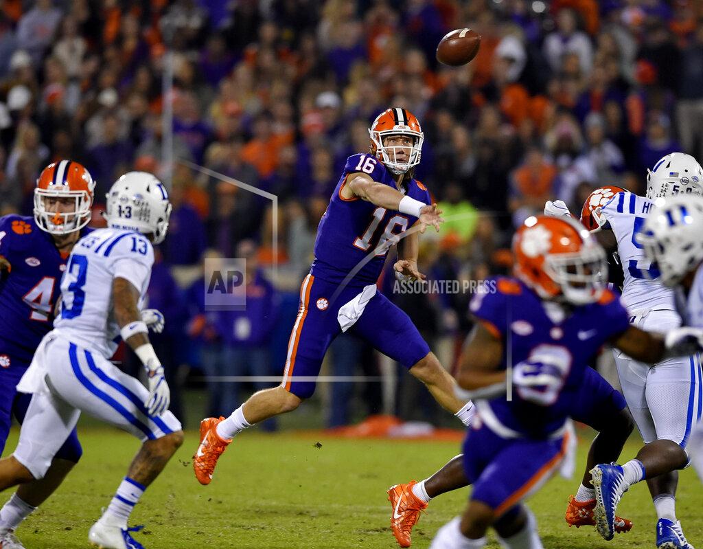 Richard Shiro FILE - In this Nov. 17, 2018, file photo, Clemson quarterback Trevor Lawrence throws a pass under pressure during the first half of an NCAA college football game against Duke, in Clemson, S.C. For the first time, the defending national champion Tigers are No. 1 in The Associated Press preseason Top 25 presented by Regions Bank, Monday, Aug. 19, 2019. Clemson won its second national title in three seasons behind freshman quarterback Trevor Lawrence to claim equal standing with Alabama at the top of the sport. (AP Photo/Richard Shiro, File)
