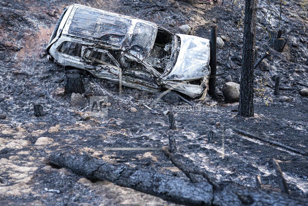 Nathan Howard A burned car damaged by the Bootleg Fire is seen here along a mountain road on Wednesday, July 21, 2021 near Bly, Ore. (AP Photo/Nathan Howard)