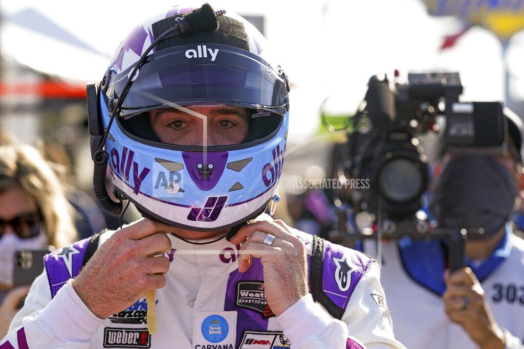 John Raoux Jimmie Johnson prepares his helmet before getting in his car to start of the Rolex 24 hour auto race at Daytona International Speedway, Saturday, Jan. 30, 2021, in Daytona Beach, Fla. (AP Photo/John Raoux)