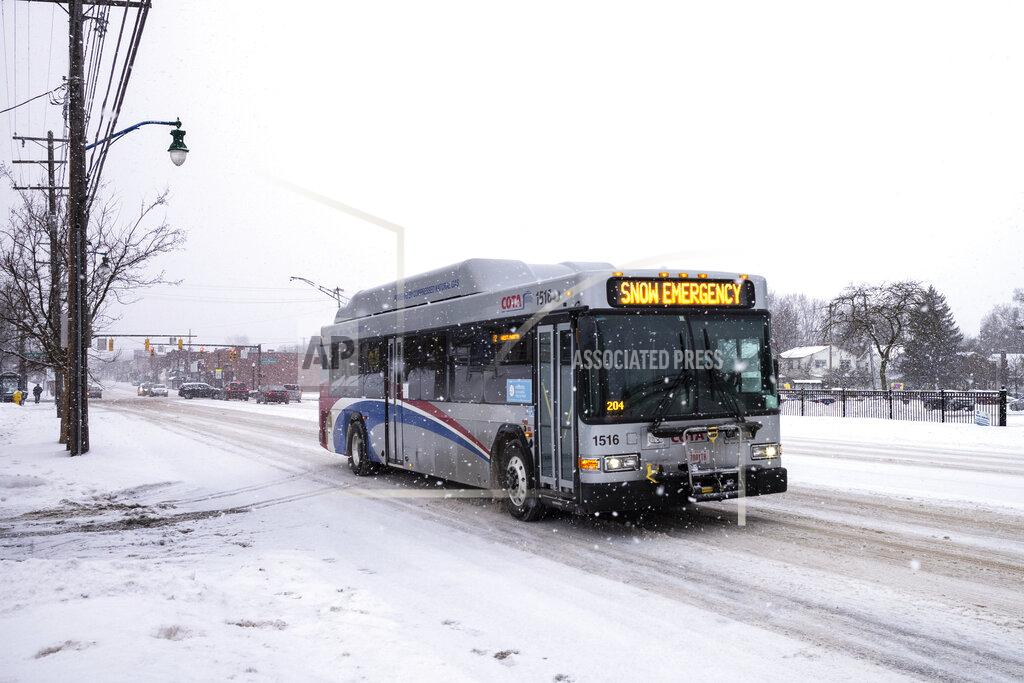A COTA bus drives north on High Street during a snow storm on Tuesday, Feb. 16, 2021 in Columbus, Ohio. The storm dropped several inches in the Columbus area overnight. (Joshua A. Bickel /The Columbus Dispatch via AP)