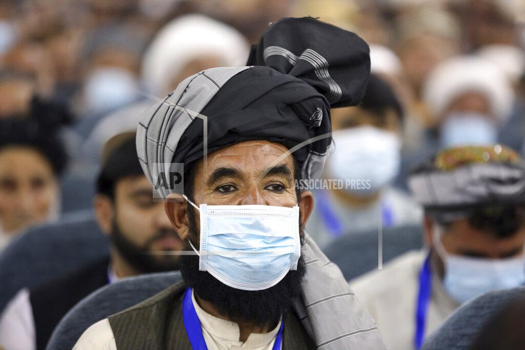 Rahmat Gul Delegates wearing a protective face masks to help curb the spread of the coronavirus attend an Afghan Loya Jirga meeting in Kabul, Afghanistan, Friday, Aug. 7, 2020. The traditional council opened Friday in the Afghan capital to decide the release of a final 400 Taliban - the last hurdle to the start of negotiations between Kabul’s political leadership and the Taliban in keeping with a peace deal the United States signed with the insurgent movement in February. (AP Photo/Rahmat Gul)