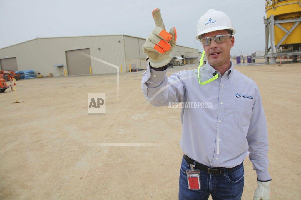 Jophn L. Mone In this Tuesday March 10, 2020 photo, David Nickerson, CEO of Marine Well Containment Company, describes the function of five cap stacks engineered by the not-for-profit disaster response consortium, in Ingleside, Texas. MWCC was created after the BP Oil disaster devastated the Gulf of Mexico ten years ago. (AP Photo/John L. Mone)
