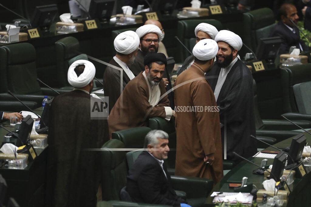 Vahid Salemi A group of cleric lawmakers speak prior to the start of the inauguration ceremony of Iran's new parliament, in Tehran, Iran, Wednesday, May, 27, 2020. Iran convened its newly elected parliament, dominated by conservative lawmakers and under strict social distancing regulations, as the country struggles to curb the spread of coronavirus that has hit the nation hard. Iran is grappling with one of the deadliest outbreaks in the Middle East. (AP Photo/Vahid Salemi)