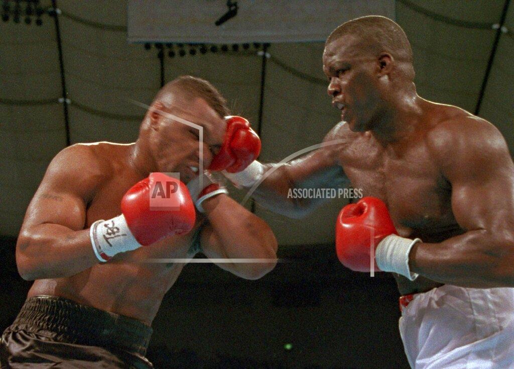 Sadayuki Mikami FILE - In this Feb. 11, 1990, file photo, James "Buster" Douglas, right, hits Mike Tyson with a hard right in the face during their world heavyweight title bout at the Tokyo Dome in Tokyo. Douglas is marking the 30th anniversary of his upset boxing victory over Tyson with a campaign aimed to inspiring others who face long odds. The 59-year-old plans to announce the “42 to 1” initiative at the Ohio Statehouse Wednesday, Oct. 30, 2019, alongside city and state leaders and two-time Heisman Trophy winner Archie Griffin. The effort will include workforce development, diversity and self-help components. (AP Photo/Sadayuki Mikami, File)