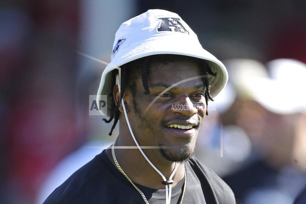 FILE - In this Jan. 25, 2020, file photo, AFC quarterback Lamar Jackson of the Baltimore Ravens smiles during Pro Bowl NFL football practice in Kissimmee, Fla. Lamar Jackson announced he will hold his annual “Funday with LJ” event in Florida amid the state's spike in coronavirus cases. Jackson's third annual event will be held Saturday and Sunday in his hometown of Pompano Beach, Florida, according to a flyer shared on his Instagram page Monday, July 6, 2020. Social gatherings in groups of more than 10 people is currently not allowed in Pompano Beach, according to the city’s website.(AP Photo/Gregory Payan, File)