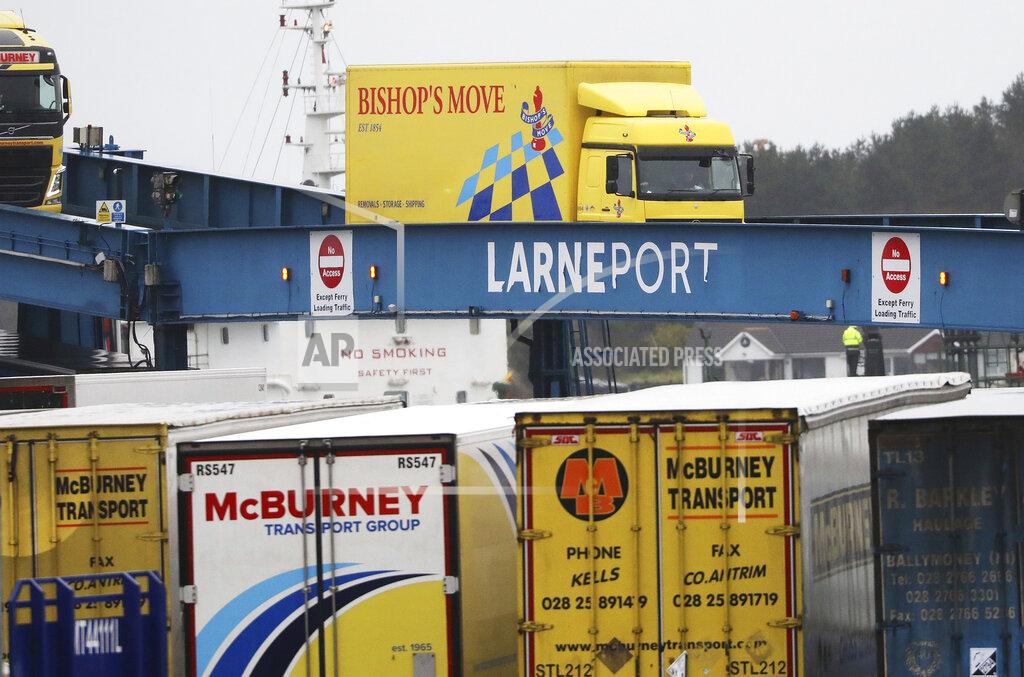 Peter Morrison Vehicles disembark from the P&O ferry arriving from Scotland at the port of Larne, Northern Ireland, Tuesday, Feb. 2, 2021. Authorities in Northern Ireland have suspended checks on animal products and withdrawn workers from two ports after threats against border staff. (AP Photo/Peter Morrison)