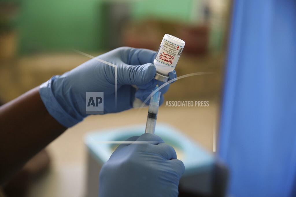 Joseph Odelyn FILE - In this Tuesday, July 27, 2021 file photo, a medical worker prepares a shot of the Moderna vaccine during a vaccination campaign at Saint Damien Hospital in Port-au-Prince, Haiti. In late June, the international system for sharing coronavirus vaccines sent about 530,000 doses to Britain – more than double the amount sent that month to the entire continent of Africa. It was the latest example of how a system that was supposed to guarantee low and middle-income countries vaccines is failing, leaving them at the mercy of haphazard donations from rich countries. (AP Photo/Joseph Odelyn, file)