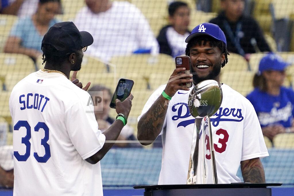 Mark J. Terrill Los Angeles Rams safety Nick Scott, left, and running back Cam Akers take pictures of each other with the Vince Lombardi Trophy during a visit by members of the Rams prior to a baseball game between the Los Angeles Dodgers and the San Francisco Giants Tuesday, May 3, 2022, in Los Angeles. (AP Photo/Mark J. Terrill)