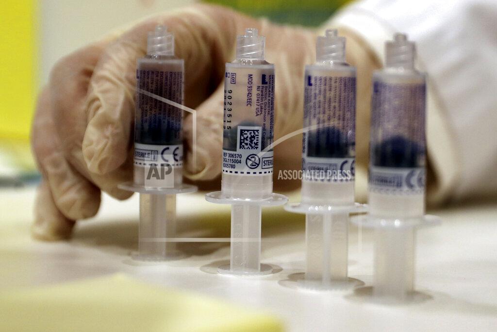 Bilal Hussein A medic prepares syringes of the Pfizer-BioNTech COVID-19 vaccine during a nationwide vaccination campaign, at the American University Medical Center in Beirut, Lebanon, Sunday, Feb. 14, 2021. (AP Photo/Bilal Hussein)