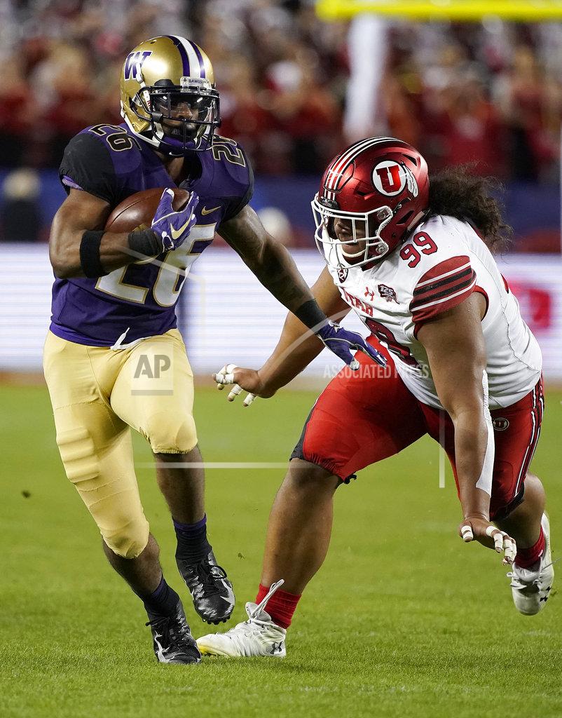 Tony Avelar Washington running back Salvon Ahmed (26) runs in front of Utah defensive tackle Leki Fotu (99) during the first half of the Pac-12 Conference championship NCAA college football game in Santa Clara, Calif., Friday, Nov. 30, 2018. (AP Photo/Tony Avelar)