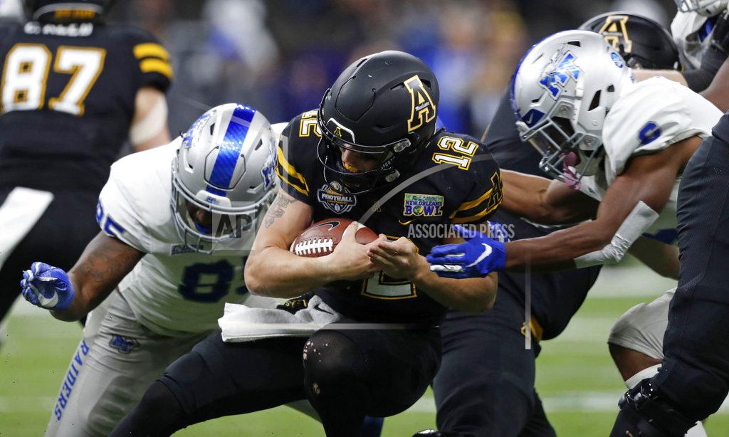 Gerald Herbert Appalachian State quarterback Zac Thomas (12) is tackled by Middle Tennessee defensive end Darrius Liggins, left, and linebacker Khalil Brooks, right, in the first half of the New Orleans Bowl NCAA college football game in New Orleans, Saturday, Dec. 15, 2018. (AP Photo/Gerald Herbert)