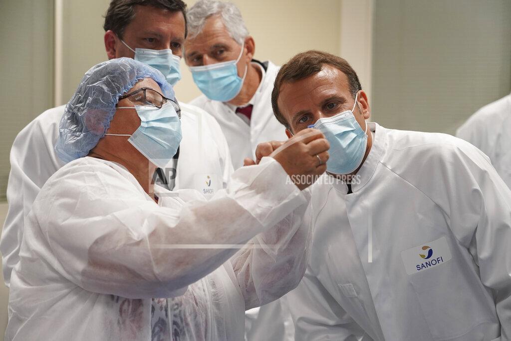 Laurent Cipriani FILE - In this June 16, 2020, file photo, French President Emmanuel Macron visits an industrial development laboratory at French drugmaker's vaccine unit Sanofi Pasteur plant in Marcy-l'Etoile, near Lyon, central France. As the race for a vaccine against the new coronavirus intensifies, many rich countries are rushing to the front of the line by placing advance orders for the inevitably limited supply to guarantee their citizens are immunized first. (AP Photo/Laurent Cipriani, Pool, File)