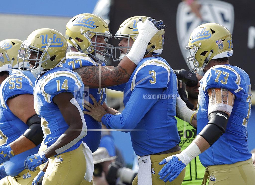 Marcio Jose Sanchez UCLA quarterback Wilton Speight (3) is hugged by teammates after scoring a rushing touchdown against Southern California during the first half of an NCAA college football game Saturday, Nov. 17, 2018, in Pasadena, Calif. (AP Photo/Marcio Jose Sanchez)