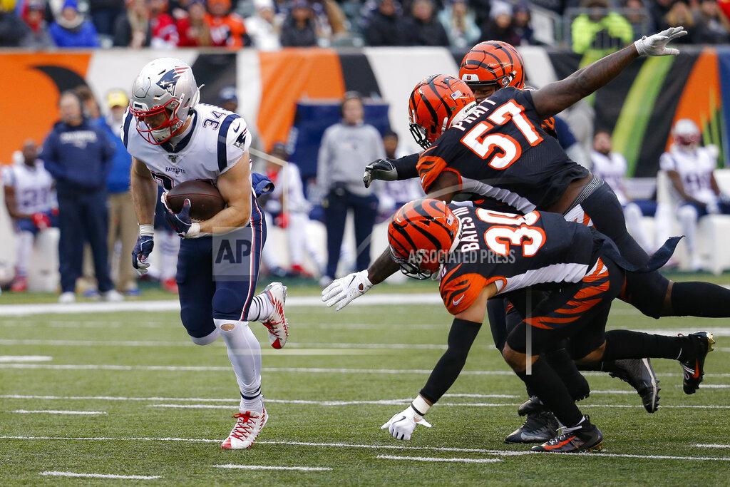 Frank Victores New England Patriots running back Rex Burkhead (34) breaks away from Cincinnati Bengals free safety Jessie Bates (30) and linebacker Germaine Pratt (57) and runs in a touchdown in the second half of an NFL football game, Sunday, Dec. 15, 2019, in Cincinnati. (AP Photo/Frank Victores)