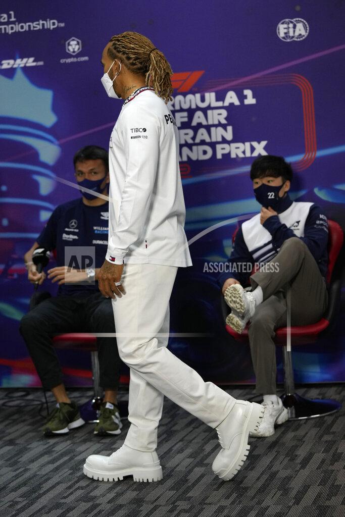 Hassan Ammar Mercedes driver Lewis Hamilton of Britain arrives to a press conference at the Formula One Bahrain International Circuit in Sakhir, Bahrain, Friday, March 18, 2022. The Bahrain Formula One Grand Prix will take place here on Sunday. (AP Photo/Hassan Ammar)