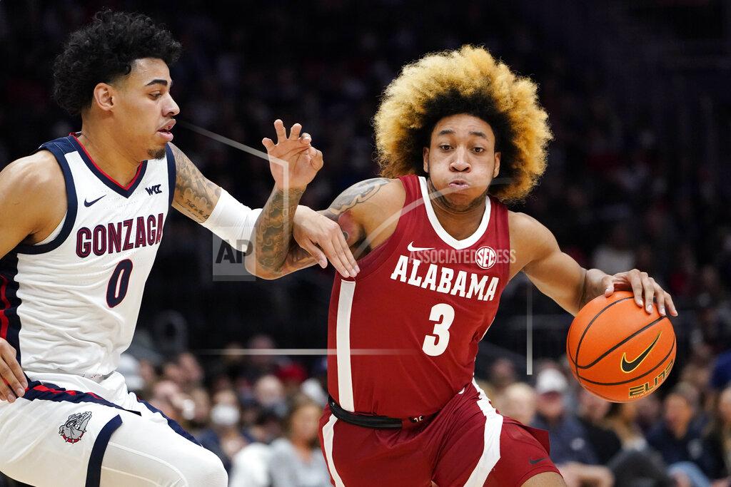 Elaine Thompson Alabama's JD Davison (3) tries to drive past Gonzaga's Julian Strawther (0) during the first half of an NCAA college basketball game Saturday, Dec. 4, 2021, in Seattle. (AP Photo/Elaine Thompson)