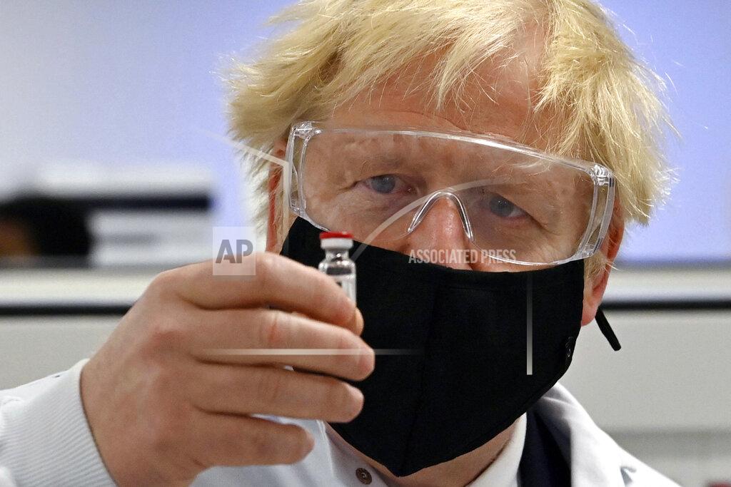 Paul Ellis Britain's Prime Minister Boris Johnson holds a vial of the Oxford/AstraZeneca vaccine Covid-19 candidate vaccine, known as AZD1222, at Wockhardt's pharmaceutical manufacturing facility in Wrexham, Wales, Monday, Nov. 30, 2020. (Paul Ellis/PA via AP)
