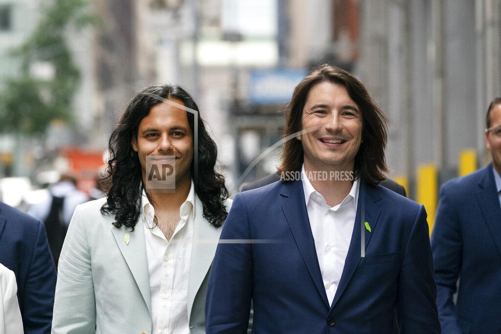 Mark Lennihan Vladimir Tenev, CEO and co-founder of Robinhood, right, walks in New York's Times Square with Baiju Bhatt, also co-founder, following their company's IPO, Thursday, July 29, 2021. Robinhood is selling its own stock on Wall Street, the very place the online brokerage has rattled with its stated goal of democratizing finance. Through its app, Robinhood has introduced millions to investing and reshaped the brokerage industry, all while racking up a long list of controversies in less than eight years. (AP Photo/Mark Lennihan)
