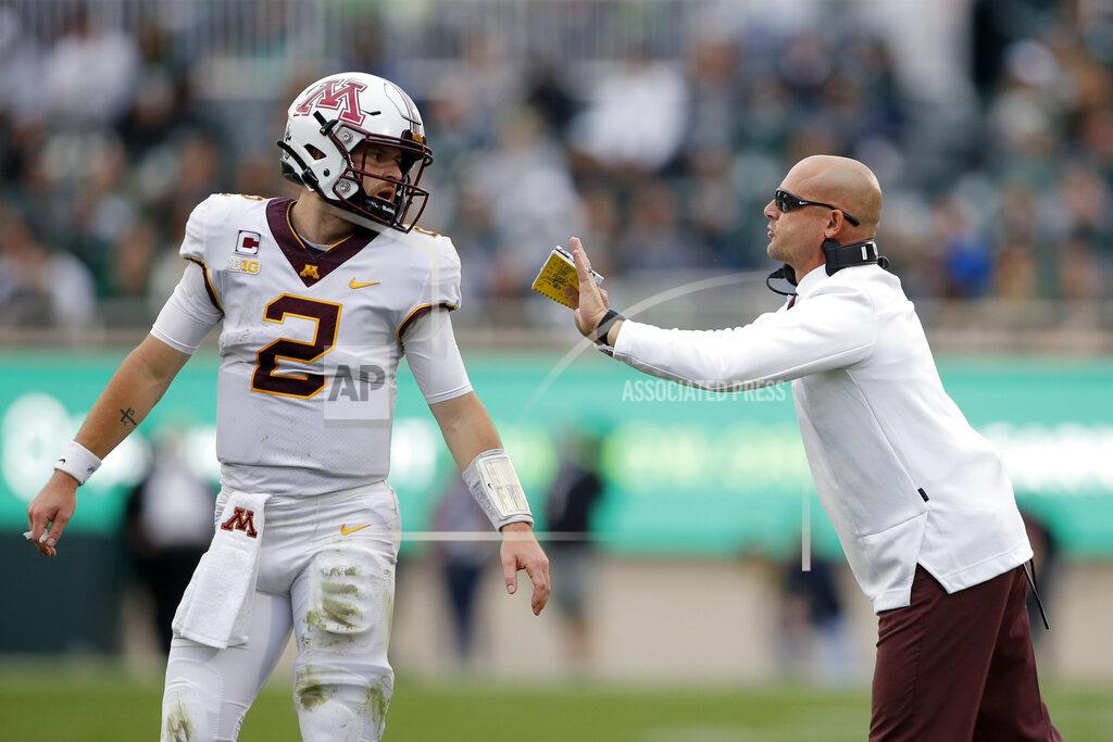 Al Goldis Minnesota coach P.J. Fleck, right, talks with quarterback Tanner Morgan during the second half of an NCAA college football game against Michigan State, Saturday, Sept. 24, 2022, in East Lansing, Mich. Minnesota won 34-7. (AP Photo/Al Goldis)