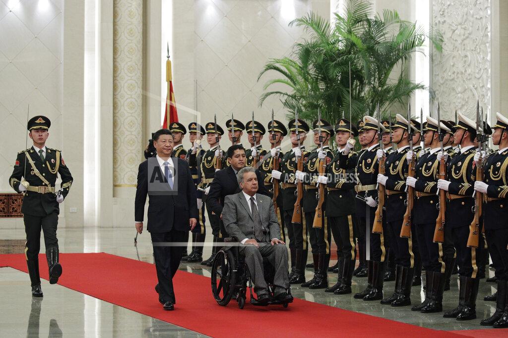 Andy Wong FILE - In this Dec. 12, 2018 file photo, Ecuador's President Lenin Moreno, right, and Chinese President Xi Jinping review an honor guard during a welcome ceremony at the Great Hall of the People in Beijing, China. In 2020, Ecuador negotiated to delay for a year nearly $900 million in debt payments serviced by oil shipments, and in 2021 the U.S. International Development Finance Corporation signed an agreement with Ecuador to finance up to $2.8 billion in infrastructure projects, money that it said could be used to “refinance predatory Chinese debt.” (AP Photo/Andy Wong, File)